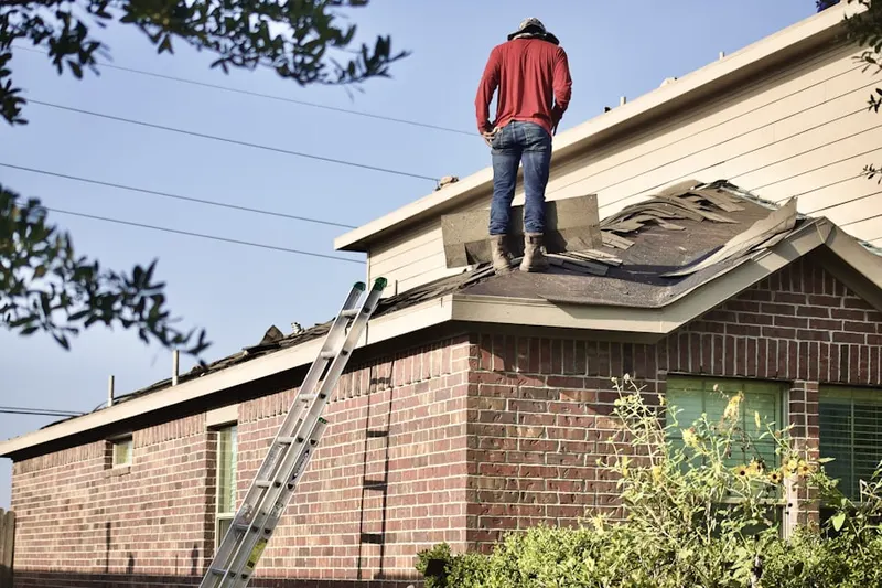 Professional roofer working on a residential roof in Pappas Colony